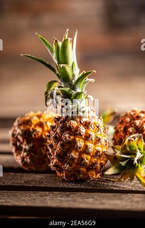 Fresh pineapples served on a vntage board. Stock Photo