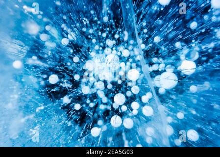 Methane gas bubbles trapped in frozen water at Lake Baikal, Siberia, Russia. Stock Photo