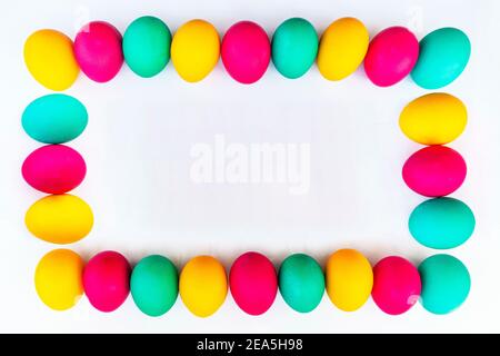 lots of colorful Easter eggs laid out in a rectangular frame. Empty center for text and design. Stock Photo