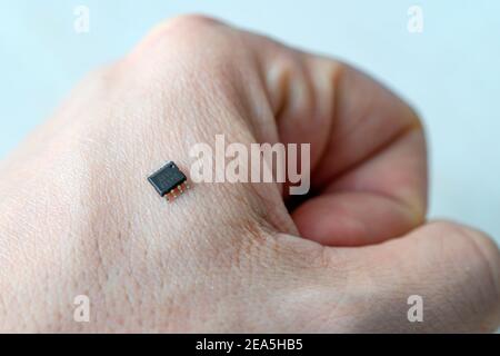 Bionic a small microchip on a man's arm - future technology and cybernetics concept Stock Photo