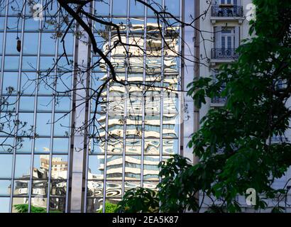 Building reflected in glass window of modern building. Stock Photo