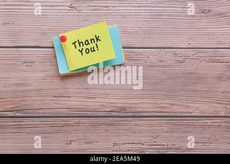 Thank you note pin on wood wall. Copy space. Stock Photo