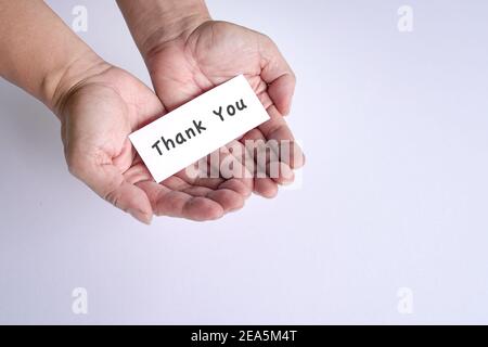 Thank you note on the open palm of man's hands. A gesture of appreciation. Stock Photo