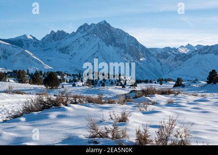 Hot Creek Geological Site is a famous landmark in Mono County. The hot springs, steam vents, curvy stream and mountain peaks create a beautiful scene. Stock Photo