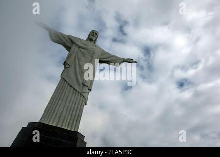 The statue of Christ the Redeemer at Rio de Janeiro in Brazil. The statue which is 30 metres high, sits atop Corcovado Mountain. Stock Photo