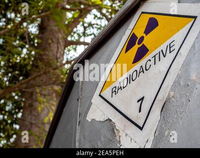 Radiation transport label Class 7 sticker affixed to the old sticker at the aluminum container of the transport truck Stock Photo