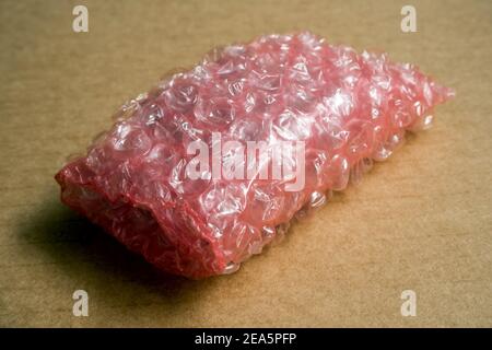 Electronic products wrapped in anti-static bubble wrap, pink color plastic bubble wrap Stock Photo