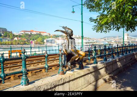 The statue of the Little Princess (Kiskirálylány) sitting on the railings of the Danube promenade in Budapest, Hungary, created by László Marton Stock Photo