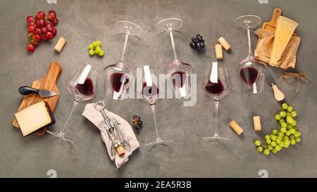 Variety of wine and snack set. Different types of grapes. Fresh ingredients on grey background. Top view Stock Photo