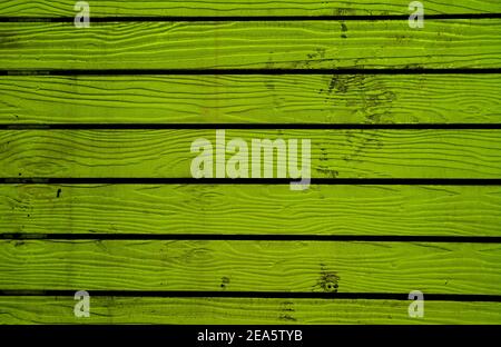 Lime green colored horizontal pattern old wooden fence background Stock Photo