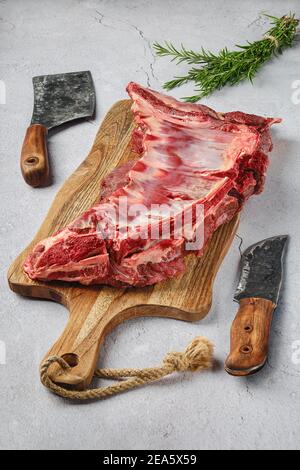 Raw fresh deer ribs with spice and herb over concrete background Stock Photo