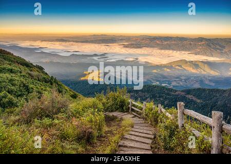 Tropical forest nature landscape view with toursits mountain range and moving cloud mist at Kew Mae Pan nature trail, Doi Inthanon, Chiang Mai Thailan Stock Photo