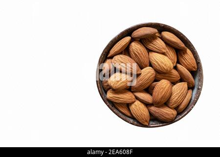 Almonds in a bowl isolated on white background. Copy space. Healthy snack. Stock Photo