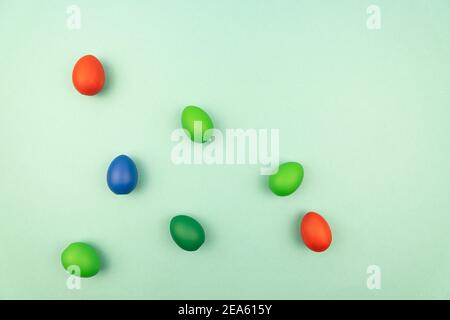 multicolored easter eggs on light blue background with copy space. Stock Photo