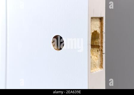 Installation of a doorknob, closeup shot Stock Photo