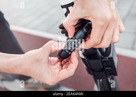a combination lock on a scooter or bicycle as a symbol of property protection and theft. Stock Photo