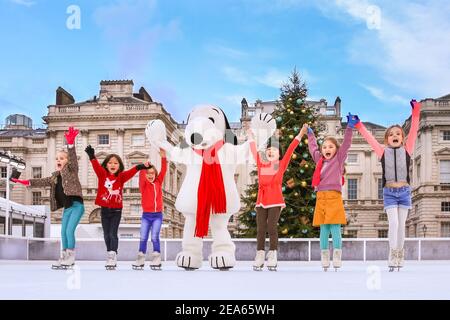 Snoopy, beagle character from the Peanuts with lilttle skaters on the ice to open Skate at Somerset House ice rink, London Stock Photo