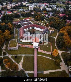 Sarvar, Hungary - Aerial drone view of the Castle of Sarvar (Nadasdy castle) with golden coloured trees and foliage on a calm autumn morning Stock Photo