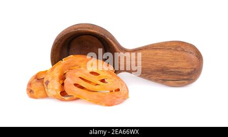 Mace in a wooden spoon, isolated on white background. Nutmeg flower, myristica fragrans. Natural spice, asian seasoning. Stock Photo