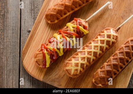 Freshly cooked corn dogs with mustard and ketchup Stock Photo