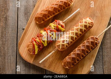 Waffle corn dogs with mustard and ketchup Stock Photo