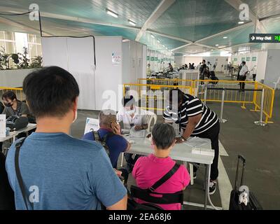 Passengers wait for Covid-19 testing prior to boarding a cruise ship at the Marina Bay Cruise Centre on February 7, 2021 in Singapore. All passengers have to be tested and demonstrate a negative result before being allowed to board the ship. (Photo by Haruhiko Otsuka/AFLO) Stock Photo