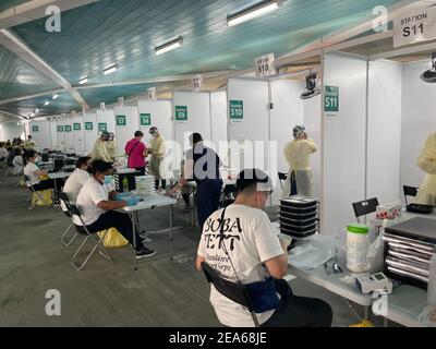 Passengers wait for Covid-19 testing prior to boarding a cruise ship at the Marina Bay Cruise Centre on February 7, 2021 in Singapore. All passengers have to be tested and demonstrate a negative result before being allowed to board the ship. (Photo by Haruhiko Otsuka/AFLO) Stock Photo