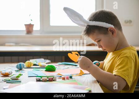 Cut out bunny blanks from multi-colored paper. Childrens handmade Easter craft, DIY Stock Photo