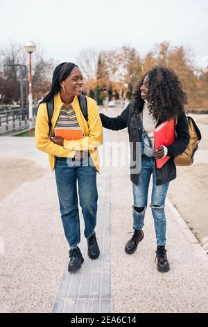 Stock photo of black students talking and laughing in the street. Stock Photo