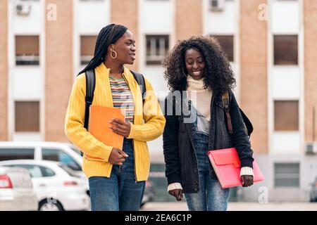 Stock photo of black students talking and laughing in the street. Stock Photo