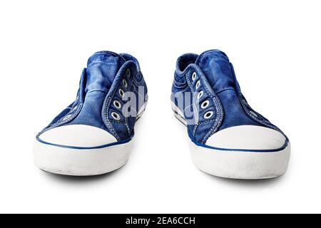 Blue sneakers on white background isolated close up, stylish rubber gumshoes without laces, pair of sport denim shoes, casual fabric boots, footwear Stock Photo