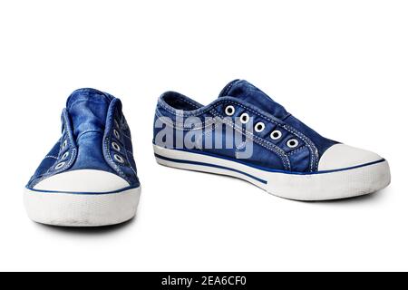 Blue sneakers on white background isolated close up, stylish rubber gumshoes without laces, pair of sport denim shoes, casual fabric boots, footwear Stock Photo