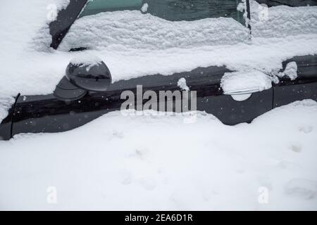 08 February 2021, Lower Saxony, Osnabrück: The driver's door of a parked car is almost completely covered with snow. Photo: Jonas Walzberg/dpa Stock Photo