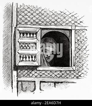 Young Arab woman looking out the window of a house in Alexandria. Ancient Egypt History. Old 19th century engraved illustration from El Mundo Ilustrado 1879 Stock Photo