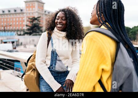 Stock photo of black students talking and laughing in the street. Stock Photo