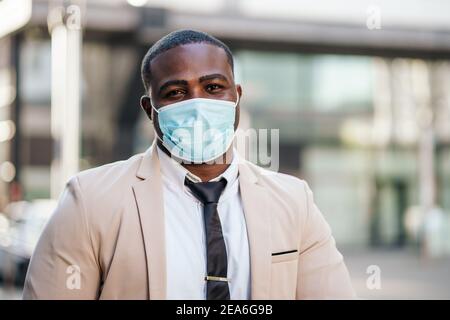 Portrait of responsible businessman who is wearing protective mask. Covid-19 virus pandemic concept. Stock Photo