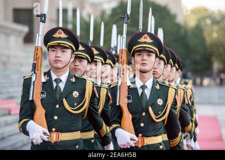 Chinese soldiers of the presidential honour guard holding rifles and weapons march in tight formation during a foreign dignity visit to the capital city of China, at the Great Hall of the People in Tiananmen Square in central Beijing © Time-Snaps Stock Photo