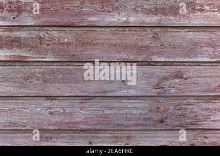 Painted wood background. High resolution image of weathered wood planks with red purple paint Stock Photo