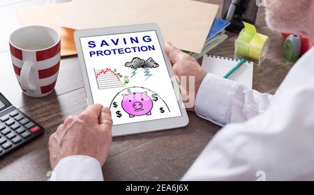 Saving protection concept shown on a tablet held by a man Stock Photo