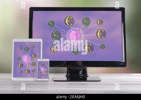 Money saving concept shown on different information technology devices Stock Photo