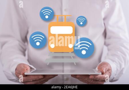 Smart train concept above a tablet held by a man in background Stock Photo