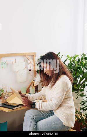 Woman checking e-mails from clients Stock Photo