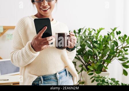 Checking notifications on smartphone Stock Photo