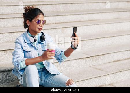 Woman taking selfie with coffee cup Stock Photo