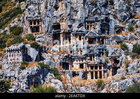 The ancient city of Myra in Turkey is a popular historical landmark that attracts numerous excursions and tourists every day. The tombs are carved rig Stock Photo