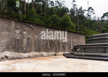 Figures graved into a grey wall in a temple on the way up to Adam's peak Stock Photo