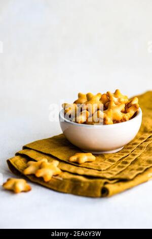 Bowl of star shaped cheese snacks on a folded napkin Stock Photo
