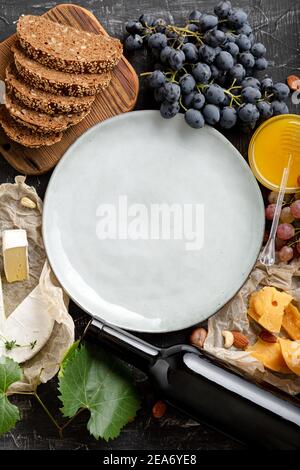 Round Plate blank or frame on grocery. Restaurant menu, template recipe. Mock up plate on full of food various table. Ceramic dish served in center Stock Photo