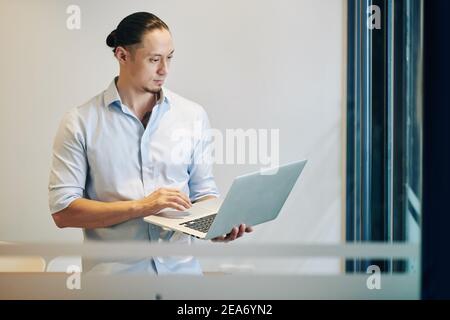 Software developer working on laptop Stock Photo