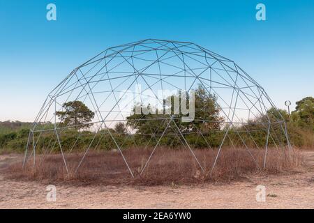 The steel frame of a geodesic dome is built on nature. Such a frame has a large load-bearing capacity and wind resistance Stock Photo